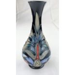 A Moorcroft baluster slender neck vase decorated with stylized leaves & flowers impressed &