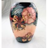 An ovoid Moorcroft vase decorated in the "Honeysuckle & Dog Roses" pattern impressed & monogrammed