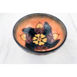 A Moorcroft bowl decorated in the Honeysuckle & Dog Rose pattern on circular foot impressed &