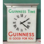 A Guinness swinging clock/advertising poster height 54cm