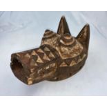 An African tribal carved wood wolf mask, carved and painted geometric decoration 29cm