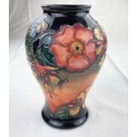 A Moorcroft inverted baluster vase decorated in the Honeysuckle & Dog Rose pattern impressed &