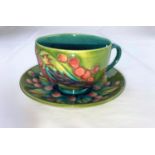 A Moorcroft Bird and Fruit "Finch" pattern cup & saucer imp & mono (seconds line in silver)