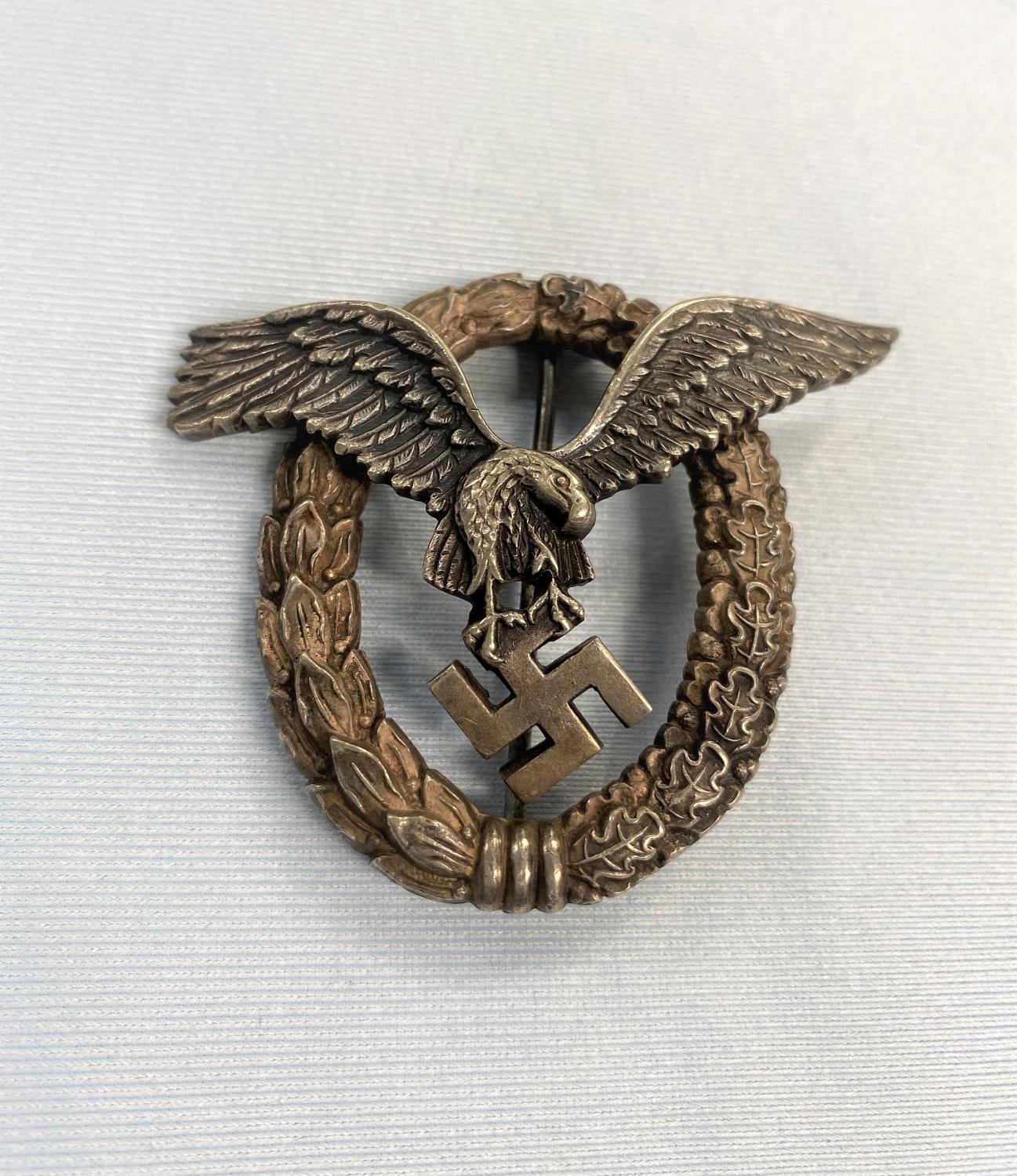 A German World War II Luftwaffe pilots badge with eagle in wreath stamped OM to back of eagle 5cm (
