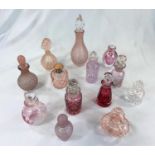 A small collection of 1930's and later scent bottles including cranberry glass and other mainly pink