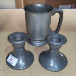 A pair of Tudric dwarf candlesticks in planished pewter, 01417; a pewter 1 pint mug