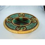 A 19th century majolica bread dish of oval form on raised foot, length 31 cm