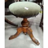 An Edwardian walnut revolving piano stool on turned centre support and 3 splay feet