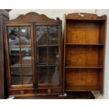 A walnut wall hanging display cabinet with 2 doors and 2 drawers; a 4 height narrow bookcase
