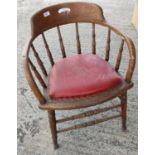 An oak smoker's / captain's stick back bow armchair with red effect leather cushion seat