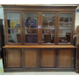 A mahogany and stained wood large shops cabinet/ library bookcase with moulded cornice and 4 glass