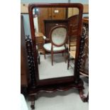 A Victorian half length cheval mirror in mahogany frame on barley twist side columns and 4 scroll