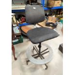 A vintage Tan-Sad revolving chair with circular footrest