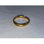 A 22 carat hallmarked gold wedding ring (cut)