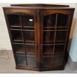 A 1930's oak display cabinet enclosed by 2 doors