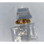 An Edwardian 18 carat hallmarked gold ring set with 3 rubies and 2 diamonds, 2.9 gm (1 diamond