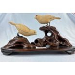 A Japanese Meiji period fine carving in ivory and hardwood depicting birds in branches, signature in