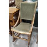 An early 20th century lightwood rocking chair with green dralon upholstery