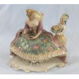 A Karl Ens Dresden group: seated crinoline lady and page, length 22 cm