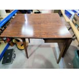 A 1960's drop leaf dining table with rosewood effect laminate top