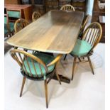 An Ercol period style dining suite in dark oak comprising rectangular refectory table, 6 (4 + 2)