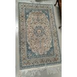 A 20th century hand knotted fawn ground middle eastern carpet 180cm x 109cm