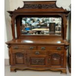 An early 20th century mahogany heavily carved (possibly Scottish) mirror back side board with four