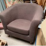 A tub shaped armchair in brown by Ikea