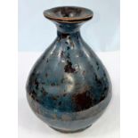 A Chinese pottery vase of ovoid form with thick brown glaze overpainted in dark blue, character mark