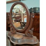 A Victorian oval dressing table mirror in mahogany free standing frame