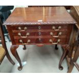 A mahogany reproduction gadrooned side table with 3 drawers, fitted for cutlery, on cabriole legs