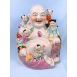 A large Chinese modern figure of seated budha with children climbing on him. Height 36cm (one