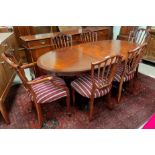 A Regency style figured mahogany dining suite with satinwood crossbanding, comprising single