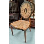 An Adam style satinwood boudoir chair with an oval cane back and cane seat, with extensive painted