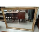 A large wall mirror in rectangular gilt frame