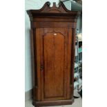 An oak inlaid corner cabinet, floor standing with swan neck pediment, height 197cm