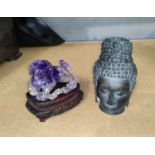 A Chinese amethyst coloured hardstone figure of dog of foe on hardwood stand (some areas damaged), a