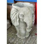 A reconstituted stone garden urn in the form of an elephant's head