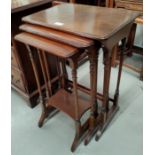 A mahogany nest of trio tables