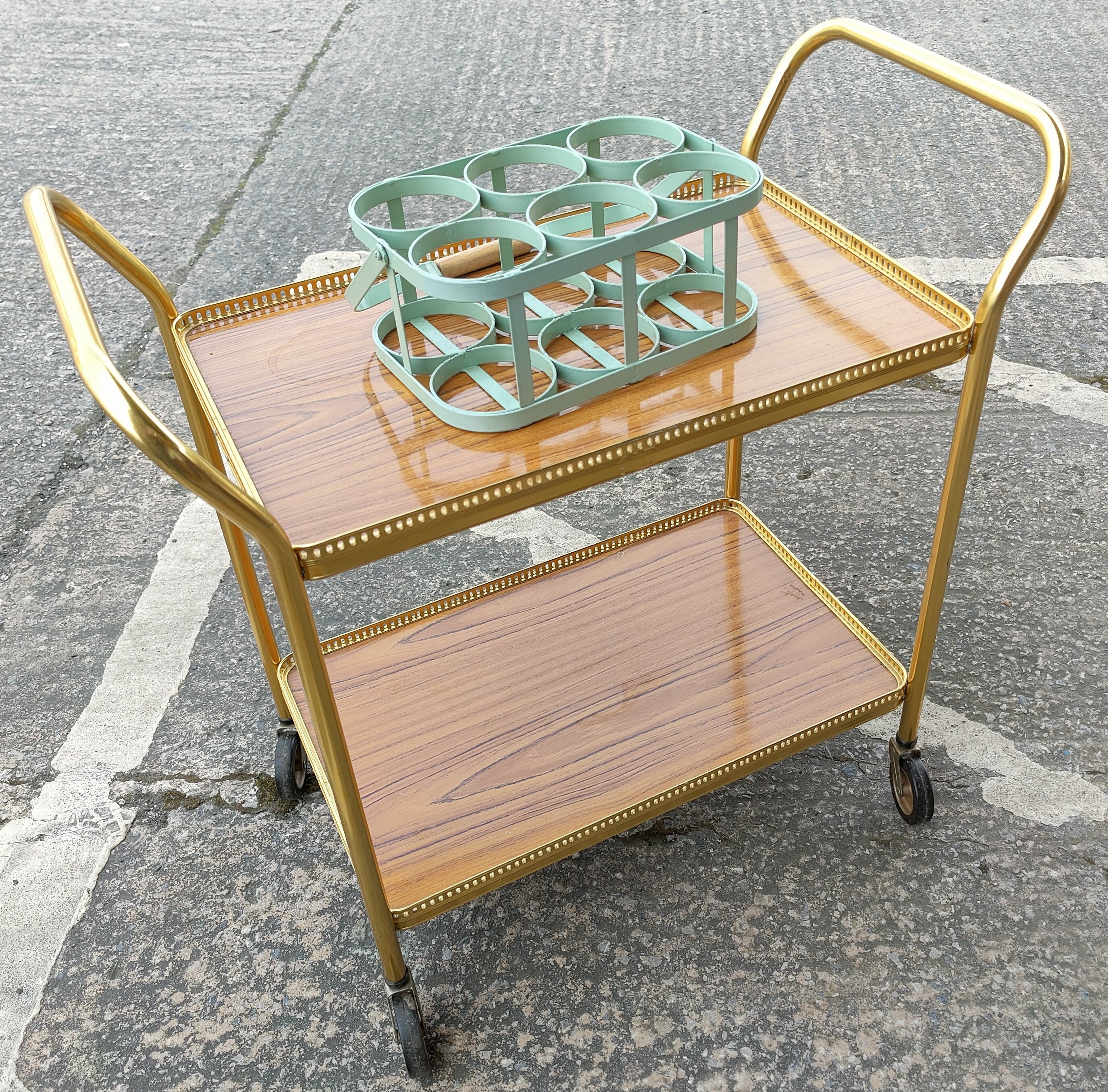 A retro style milk/bottle carrier (small bolt missing), a vintage gilt cocktail trolly