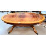 A period style crossbanded mahogany coffee table with oval top, on splay legs