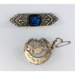 A vintage white metal Art Deco brooch with large blue sapphire colour stone & white spinels,
