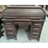 An early 20th century 'D' front oak, roll top kneehole desk