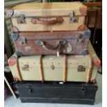 A metal trunk; a wood bound trunk; 2 old suitcases