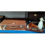 An old leather suitcase; a smaller suitcase; a 19th century walnut and Tunbridgeware tea caddy; a