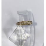 A yellow gold half eternity ring with 9 baguette cut diamonds (approximately 1ct) stamped 18K size M