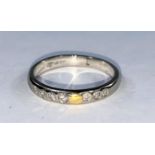 A white metal wedding ring set 2 rows of 4 x 3 small diamonds, bearing foreign marks, tests as circa