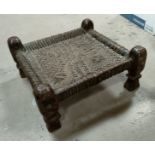 An Indian carved hardwood and woven leather plant seat 39cm