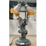 A bronzed effect table lamp depicting a fairy sat on a mushroom with Tiffany style wings, trio