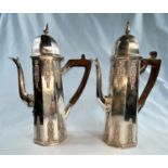 A hallmarked silver pair of 'cafe au lait' pots, octagonal with domed tops and relief decoration